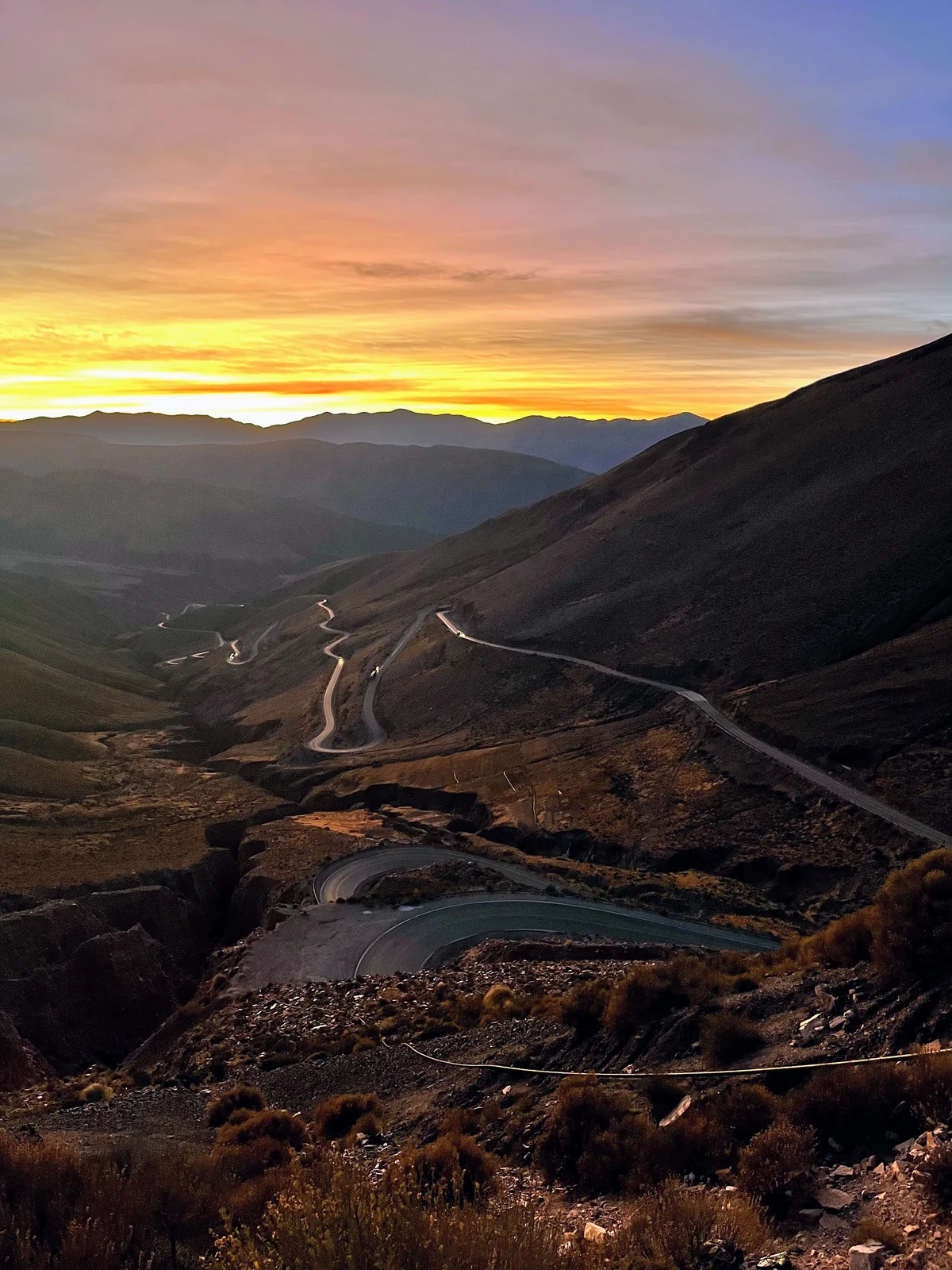 A winding mountain road at sunset